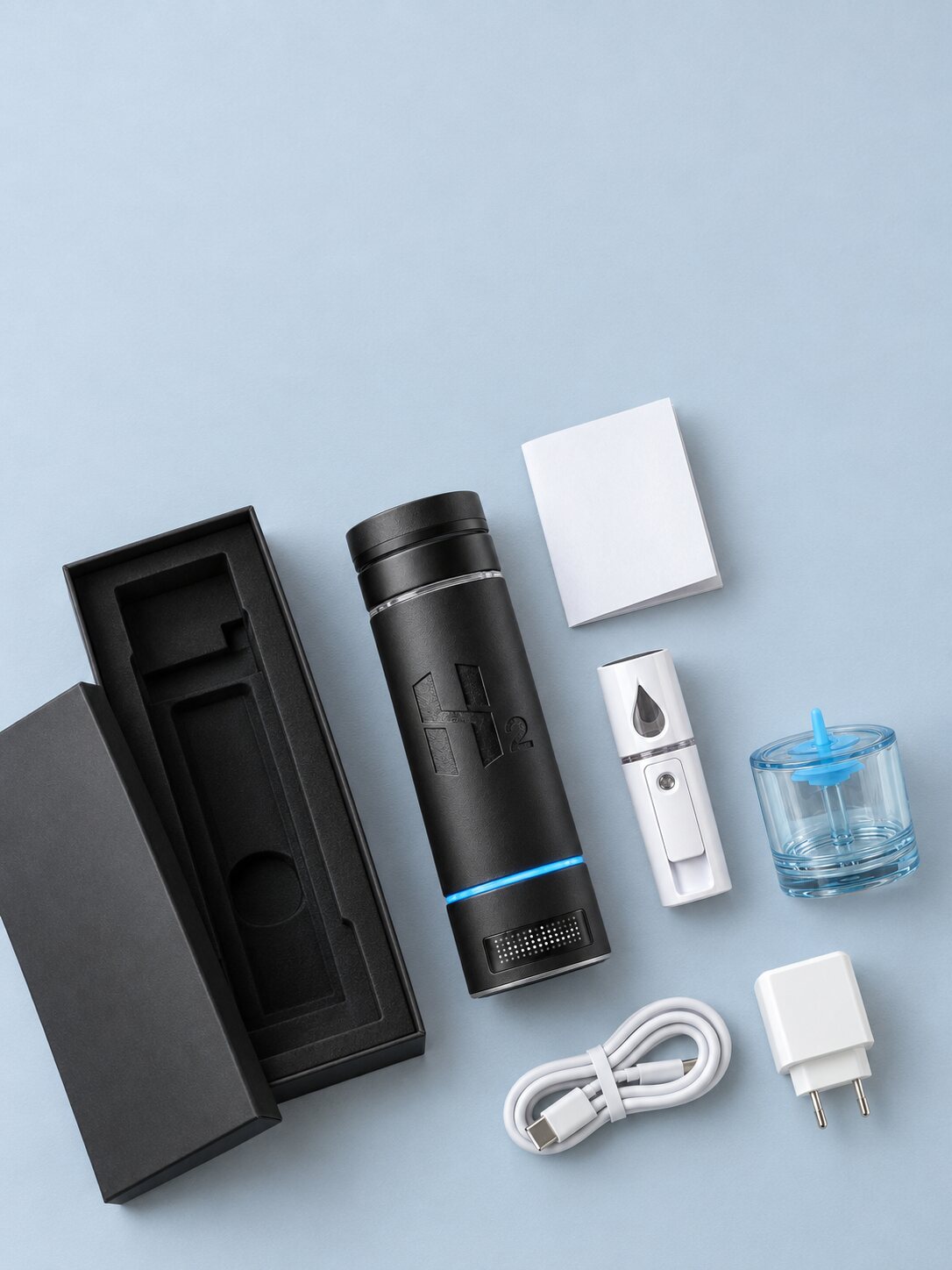 The HydroMax bottle with its gift box, mist sprayer, inhalation adapter, charging cable and plug