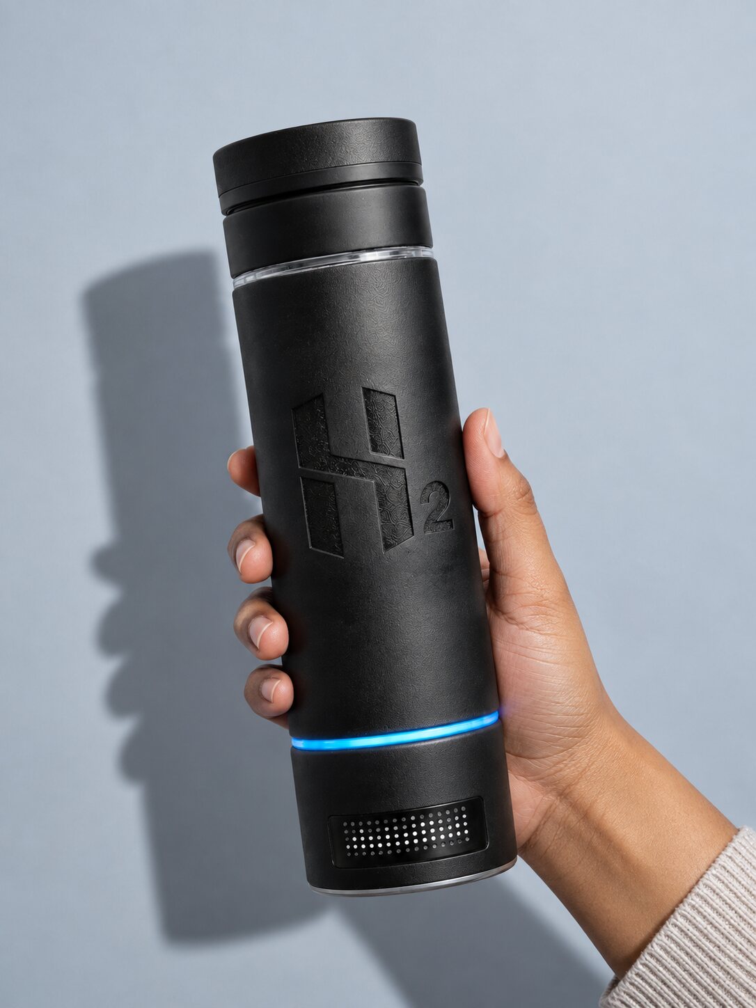 The HydroMax bottle held up in daylight, its blue ring lit