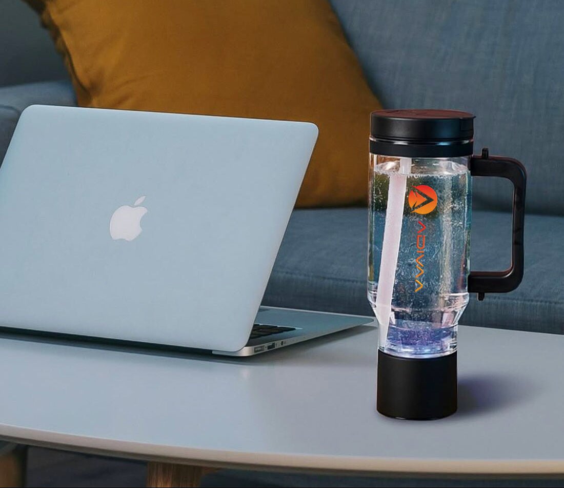 The black HydroSipr beside a laptop, its base glowing mid-cycle