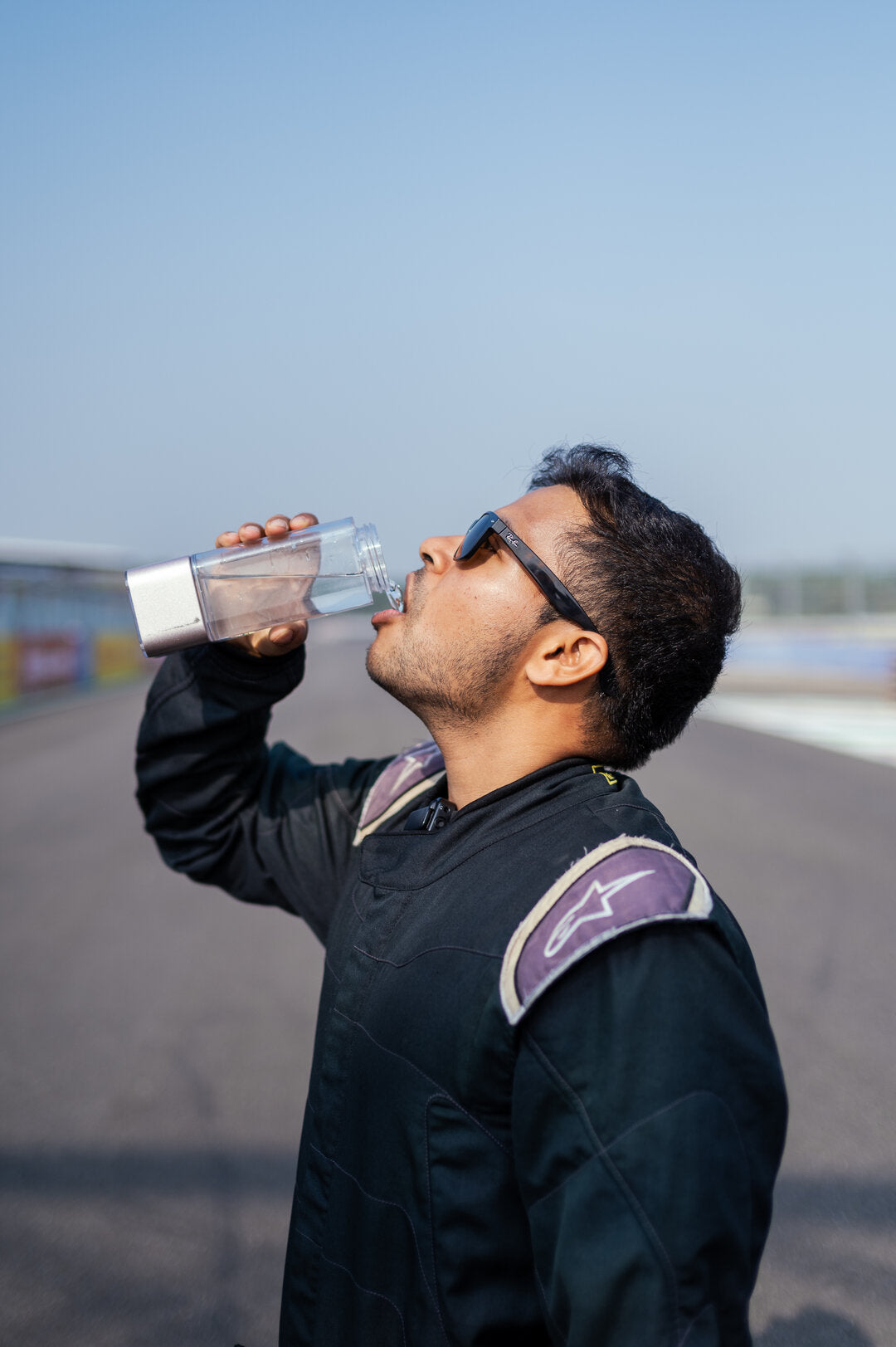 A racing driver drinking from the HydroUltra at the track