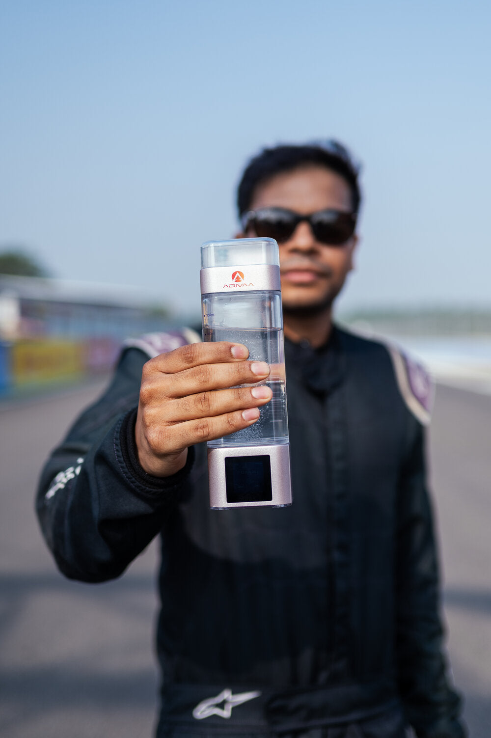 A racing driver holding the HydroUltra out to camera